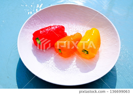 Red, yellow, and orange peppers with water droplets Red, yellow, and orange peppers with water droplets 136699063