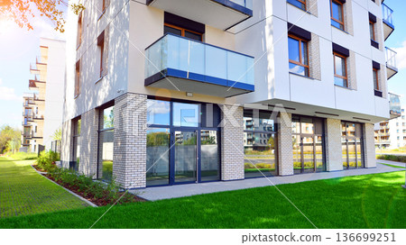 The garden of a modern residential building with a green lawn and a place to relax. 136699251