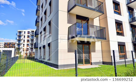 The garden of a modern residential building with a green lawn and a place to relax. 136699252