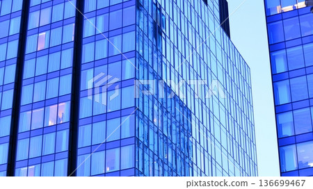 Modern sustainable glass office buildings. Exterior view of corporate headquarters glass buildings architecture.Glass windows in energy-efficient buildings. Financial business center buildings. Modern sustainable glass office buildings. Exterior view of corporate headquarters glass buildings architecture.Glass windows in energy-efficient buildings. Financial business center buildings. 136699467