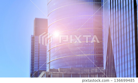 Modern sustainable glass office buildings. Exterior view of corporate headquarters glass buildings architecture.Glass windows in energy-efficient buildings. Financial business center buildings. Modern sustainable glass office buildings. Exterior view of corporate headquarters glass buildings architecture.Glass windows in energy-efficient buildings. Financial business center buildings. 136699485