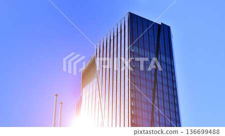 Modern sustainable glass office buildings. Exterior view of corporate headquarters glass buildings architecture.Glass windows in energy-efficient buildings. Financial business center buildings. Modern sustainable glass office buildings. Exterior view of corporate headquarters glass buildings architecture.Glass windows in energy-efficient buildings. Financial business center buildings. 136699488