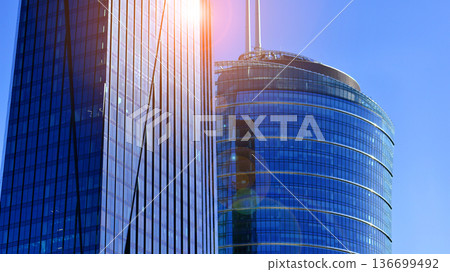 Modern sustainable glass office buildings. Exterior view of corporate headquarters glass buildings architecture.Glass windows in energy-efficient buildings. Financial business center buildings.  136699492