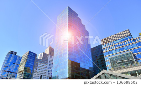 Modern sustainable glass office buildings. Exterior view of corporate headquarters glass buildings architecture.Glass windows in energy-efficient buildings. Financial business center buildings. Modern sustainable glass office buildings. Exterior view of corporate headquarters glass buildings architecture.Glass windows in energy-efficient buildings. Financial business center buildings. 136699502