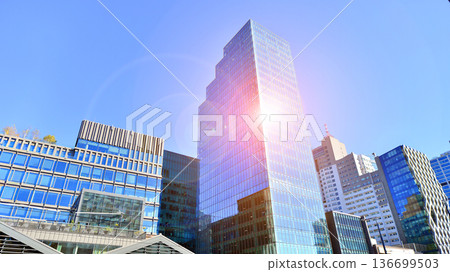 Modern sustainable glass office buildings. Exterior view of corporate headquarters glass buildings architecture.Glass windows in energy-efficient buildings. Financial business center buildings. Modern sustainable glass office buildings. Exterior view of corporate headquarters glass buildings architecture.Glass windows in energy-efficient buildings. Financial business center buildings. 136699503