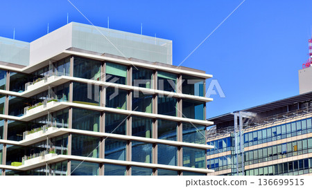 Modern sustainable glass office buildings. Exterior view of corporate headquarters glass buildings architecture.Glass windows in energy-efficient buildings. Financial business center buildings.  136699515
