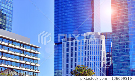 Modern sustainable glass office buildings. Exterior view of corporate headquarters glass buildings architecture.Glass windows in energy-efficient buildings. Financial business center buildings. Modern sustainable glass office buildings. Exterior view of corporate headquarters glass buildings architecture.Glass windows in energy-efficient buildings. Financial business center buildings. 136699519