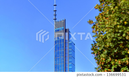 Modern sustainable glass office buildings. Exterior view of corporate headquarters glass buildings architecture.Glass windows in energy-efficient buildings. Financial business center buildings. Modern sustainable glass office buildings. Exterior view of corporate headquarters glass buildings architecture.Glass windows in energy-efficient buildings. Financial business center buildings. 136699531