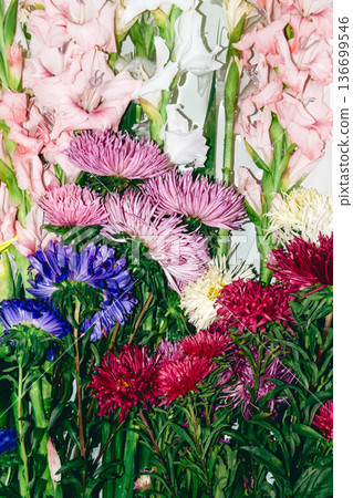 Close up of pink gladiolus and colorful aster flowers in dense bouquet. Sustainable gardening, local blooms, slow flower movement, seasonal farming. 136699546