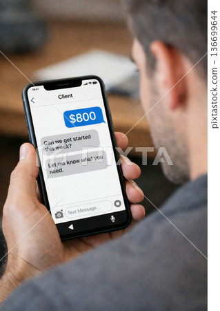 A close-up of a mobile phone screen, a message from a customer, and the receipt of a prepayment 136699644