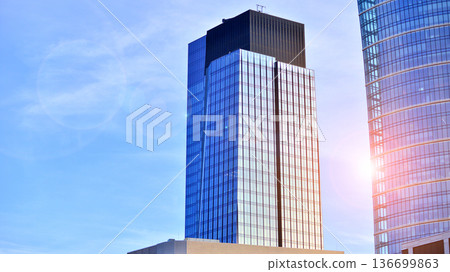 Modern sustainable glass office buildings. Exterior view of corporate headquarters glass buildings architecture.Glass windows in energy-efficient buildings. Financial business center buildings. Modern sustainable glass office buildings. Exterior view of corporate headquarters glass buildings architecture.Glass windows in energy-efficient buildings. Financial business center buildings. 136699863