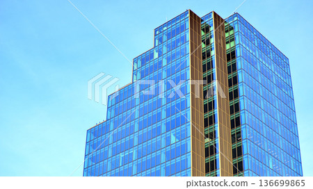 Modern sustainable glass office buildings. Exterior view of corporate headquarters glass buildings architecture.Glass windows in energy-efficient buildings. Financial business center buildings.  136699865
