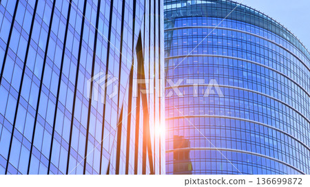 Modern sustainable glass office buildings. Exterior view of corporate headquarters glass buildings architecture.Glass windows in energy-efficient buildings. Financial business center buildings.  136699872