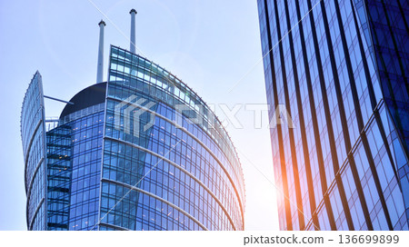 Modern sustainable glass office buildings. Exterior view of corporate headquarters glass buildings architecture.Glass windows in energy-efficient buildings. Financial business center buildings.  136699899