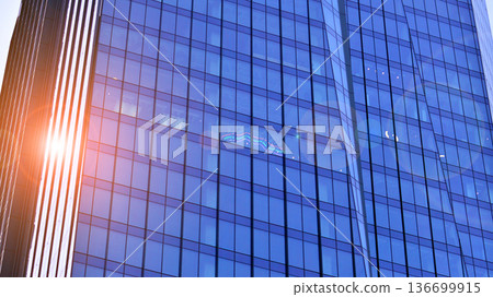 Modern sustainable glass office buildings. Exterior view of corporate headquarters glass buildings architecture.Glass windows in energy-efficient buildings. Financial business center buildings. Modern sustainable glass office buildings. Exterior view of corporate headquarters glass buildings architecture.Glass windows in energy-efficient buildings. Financial business center buildings. 136699915