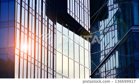 Modern sustainable glass office buildings. Exterior view of corporate headquarters glass buildings architecture.Glass windows in energy-efficient buildings. Financial business center buildings.  136699917