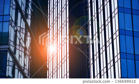 Modern sustainable glass office buildings. Exterior view of corporate headquarters glass buildings architecture.Glass windows in energy-efficient buildings. Financial business center buildings.  136699918