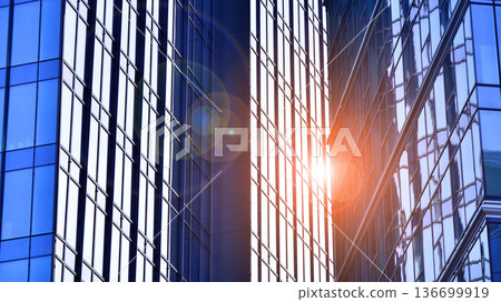 Modern sustainable glass office buildings. Exterior view of corporate headquarters glass buildings architecture.Glass windows in energy-efficient buildings. Financial business center buildings.  136699919