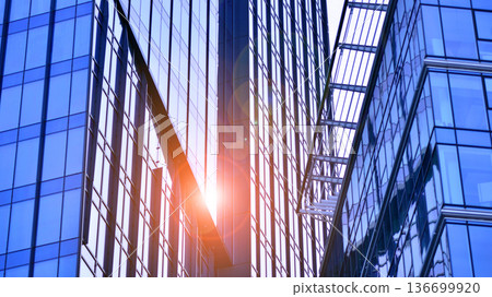 Modern sustainable glass office buildings. Exterior view of corporate headquarters glass buildings architecture.Glass windows in energy-efficient buildings. Financial business center buildings.  136699920