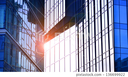 Modern sustainable glass office buildings. Exterior view of corporate headquarters glass buildings architecture.Glass windows in energy-efficient buildings. Financial business center buildings.  136699922