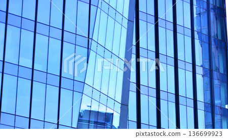 Modern sustainable glass office buildings. Exterior view of corporate headquarters glass buildings architecture.Glass windows in energy-efficient buildings. Financial business center buildings. Modern sustainable glass office buildings. Exterior view of corporate headquarters glass buildings architecture.Glass windows in energy-efficient buildings. Financial business center buildings. 136699923