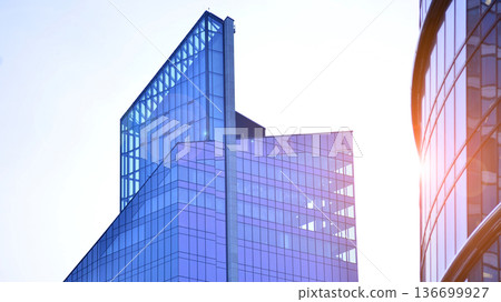 Modern sustainable glass office buildings. Exterior view of corporate headquarters glass buildings architecture.Glass windows in energy-efficient buildings. Financial business center buildings. Modern sustainable glass office buildings. Exterior view of corporate headquarters glass buildings architecture.Glass windows in energy-efficient buildings. Financial business center buildings. 136699927