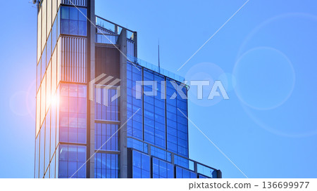 Exterior view of corporate headquarters glass buildings architecture. Modern sustainable glass office buildings. Glass windows in energy-efficient buildings. Financial business center buildings. Exterior view of corporate headquarters glass buildings architecture. Modern sustainable glass office buildings. Glass windows in energy-efficient buildings. Financial business center buildings. 136699977
