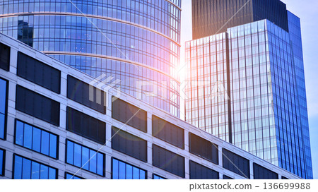 Exterior view of corporate headquarters glass buildings architecture. Modern sustainable glass office buildings. Glass windows in energy-efficient buildings. Financial business center buildings. Exterior view of corporate headquarters glass buildings architecture. Modern sustainable glass office buildings. Glass windows in energy-efficient buildings. Financial business center buildings. 136699988