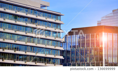 Exterior view of corporate headquarters glass buildings architecture. Modern sustainable glass office buildings. Glass windows in energy-efficient buildings. Financial business center buildings. Exterior view of corporate headquarters glass buildings architecture. Modern sustainable glass office buildings. Glass windows in energy-efficient buildings. Financial business center buildings. 136699999