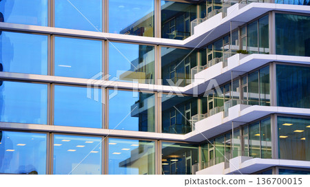 Exterior view of corporate headquarters glass buildings architecture. Modern sustainable glass office buildings. Glass windows in energy-efficient buildings. Financial business center buildings. Exterior view of corporate headquarters glass buildings architecture. Modern sustainable glass office buildings. Glass windows in energy-efficient buildings. Financial business center buildings. 136700015