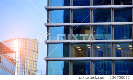 Exterior view of corporate headquarters glass buildings architecture. Modern sustainable glass office buildings. Glass windows in energy-efficient buildings. Financial business center buildings. Exterior view of corporate headquarters glass buildings architecture. Modern sustainable glass office buildings. Glass windows in energy-efficient buildings. Financial business center buildings. 136700022