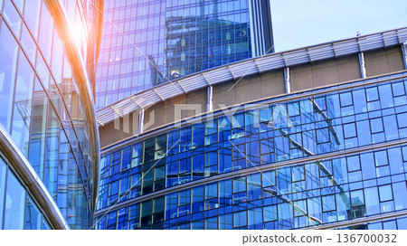 Exterior view of corporate headquarters glass buildings architecture. Modern sustainable glass office buildings. Glass windows in energy-efficient buildings. Financial business center buildings. Exterior view of corporate headquarters glass buildings architecture. Modern sustainable glass office buildings. Glass windows in energy-efficient buildings. Financial business center buildings. 136700032