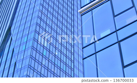 Exterior view of corporate headquarters glass buildings architecture. Modern sustainable glass office buildings. Glass windows in energy-efficient buildings. Financial business center buildings. Exterior view of corporate headquarters glass buildings architecture. Modern sustainable glass office buildings. Glass windows in energy-efficient buildings. Financial business center buildings. 136700033