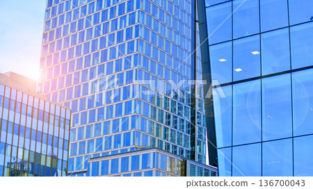Exterior view of corporate headquarters glass buildings architecture. Modern sustainable glass office buildings. Glass windows in energy-efficient buildings. Financial business center buildings. Exterior view of corporate headquarters glass buildings architecture. Modern sustainable glass office buildings. Glass windows in energy-efficient buildings. Financial business center buildings. 136700043