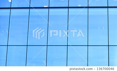 Exterior view of corporate headquarters glass buildings architecture. Modern sustainable glass office buildings. Glass windows in energy-efficient buildings. Financial business center buildings.  136700046