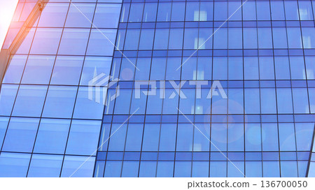 Exterior view of corporate headquarters glass buildings architecture. Modern sustainable glass office buildings. Glass windows in energy-efficient buildings. Financial business center buildings. Exterior view of corporate headquarters glass buildings architecture. Modern sustainable glass office buildings. Glass windows in energy-efficient buildings. Financial business center buildings. 136700050