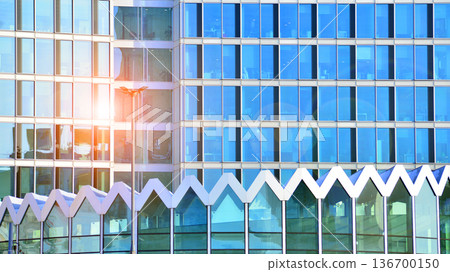 Exterior view of corporate headquarters glass buildings architecture. Modern sustainable glass office buildings. Glass windows in energy-efficient buildings. Financial business center buildings. Exterior view of corporate headquarters glass buildings architecture. Modern sustainable glass office buildings. Glass windows in energy-efficient buildings. Financial business center buildings. 136700150