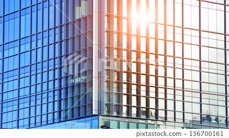 Exterior view of corporate headquarters glass buildings architecture. Modern sustainable glass office buildings. Glass windows in energy-efficient buildings. Financial business center buildings.  136700161