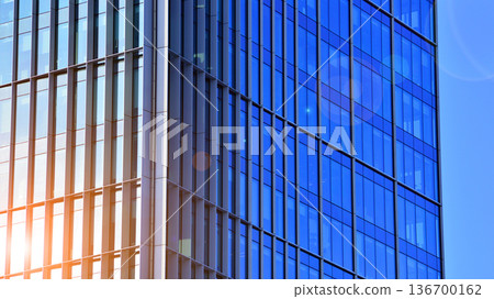 Exterior view of corporate headquarters glass buildings architecture. Modern sustainable glass office buildings. Glass windows in energy-efficient buildings. Financial business center buildings. Exterior view of corporate headquarters glass buildings architecture. Modern sustainable glass office buildings. Glass windows in energy-efficient buildings. Financial business center buildings. 136700162