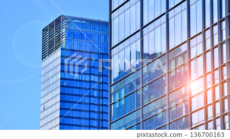 Exterior view of corporate headquarters glass buildings architecture. Modern sustainable glass office buildings. Glass windows in energy-efficient buildings. Financial business center buildings. Exterior view of corporate headquarters glass buildings architecture. Modern sustainable glass office buildings. Glass windows in energy-efficient buildings. Financial business center buildings. 136700163