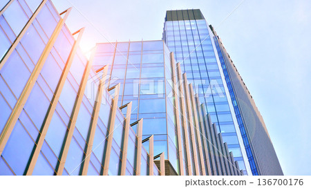 Exterior view of corporate headquarters glass buildings architecture. Modern sustainable glass office buildings. Glass windows in energy-efficient buildings. Financial business center buildings. Exterior view of corporate headquarters glass buildings architecture. Modern sustainable glass office buildings. Glass windows in energy-efficient buildings. Financial business center buildings. 136700176