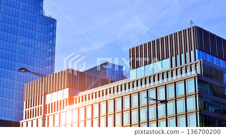 Exterior view of corporate headquarters glass buildings architecture. Modern sustainable glass office buildings. Glass windows in energy-efficient buildings. Financial business center buildings.  136700200