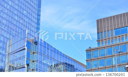 Exterior view of corporate headquarters glass buildings architecture. Modern sustainable glass office buildings. Glass windows in energy-efficient buildings. Financial business center buildings.  136700201