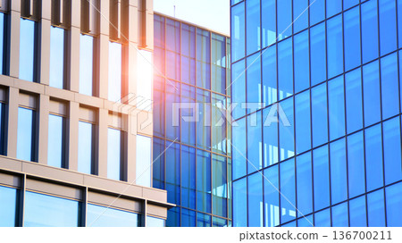 Exterior view of corporate headquarters glass buildings architecture. Modern sustainable glass office buildings. Glass windows in energy-efficient buildings. Financial business center buildings. Exterior view of corporate headquarters glass buildings architecture. Modern sustainable glass office buildings. Glass windows in energy-efficient buildings. Financial business center buildings. 136700211
