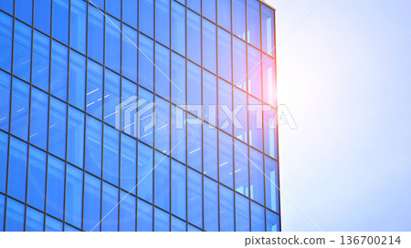 Exterior view of corporate headquarters glass buildings architecture. Modern sustainable glass office buildings. Glass windows in energy-efficient buildings. Financial business center buildings.  136700214