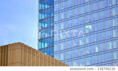 Exterior view of corporate headquarters glass buildings architecture. Modern sustainable glass office buildings. Glass windows in energy-efficient buildings. Financial business center buildings.  136700216