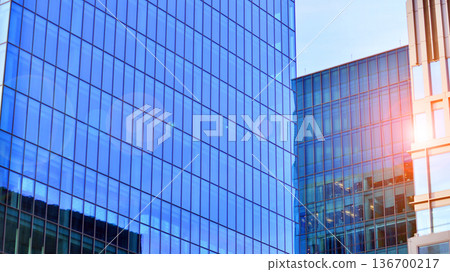 Exterior view of corporate headquarters glass buildings architecture. Modern sustainable glass office buildings. Glass windows in energy-efficient buildings. Financial business center buildings. Exterior view of corporate headquarters glass buildings architecture. Modern sustainable glass office buildings. Glass windows in energy-efficient buildings. Financial business center buildings. 136700217