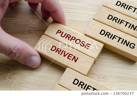 Purpose and Direction text on wooden blocks representing finding purpose and meaning when direction feels unclear 136700237