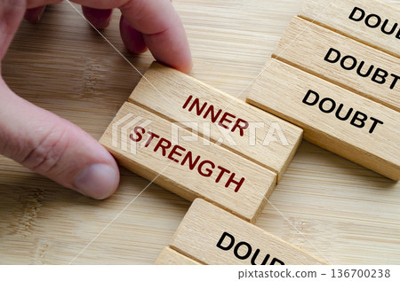 Doubt and Inner Strength text on wooden blocks representing building inner strength to overcome doubt and fear 136700238