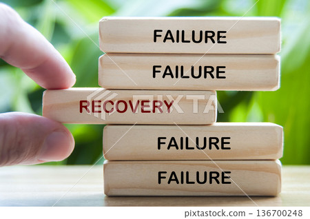 Failure and Recovery text on wooden blocks representing bouncing back from failure through learning and resilience Failure and Recovery text on wooden blocks representing bouncing back from failure through learning and resilience 136700248